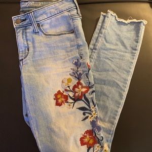 Flowers sticking down the left side leg.